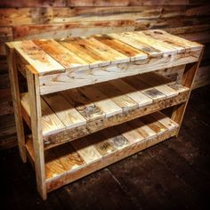 a table made out of pallet wood with one shelf on the bottom and two shelves below