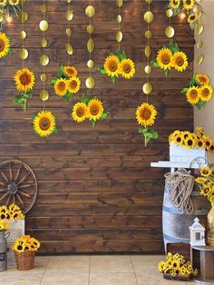 the sunflowers are hanging from the wooden wall