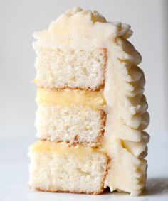 a piece of cake with white frosting and bananas on top