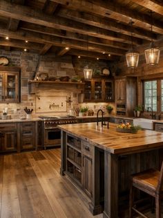 a large kitchen with wooden floors and lots of counter space, lights above the island