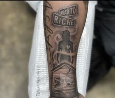 a man with a tattoo on his arm that says road to riche