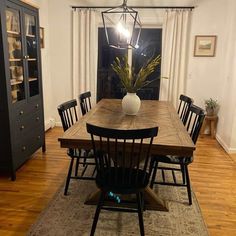 An easy way to add storage to your dining space is to include a hutch or China cabinet. This cabinet was painted a deep navy blue and finished with gold hardware to make it cohesive with the rest of the modern space...   Image: yourhomedecorfriend_