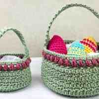 two crocheted baskets with eggs in them