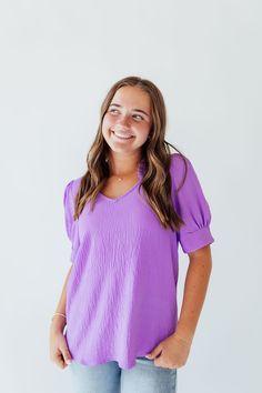 Indulge in the vibrant and joyful energy of Amy In Purple. The ruffle v-neck and banded sleeves add a playful touch to this elegant design. With its stunning purple hue, this piece is sure to brighten up your wardrobe and your day. Fits true to size. Model is wearing a small and is 5'3". Model in try on video is wearing a 2X and is 5'11". Size Chart Length Bust S 24" 38" M 24" 40" L 25" 42" 1x 26" 46" 2x 27" 48" 3x 27" 52" *All measurements are approximate and done while hanging.* Fabric and Car Day Fits, Tiered Dresses, Teen Dress, Hanging Fabric, Spring Fits, Purple Hues, White Outfits, Floral Maxi Dress, Jeans Dress