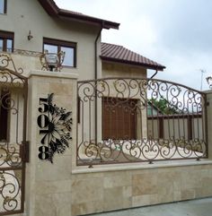 an iron gate is in front of a house