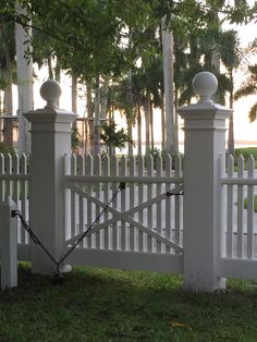 a white picket fence with chains on it