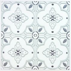 four white and black tiles with different designs on the sides, one is in an ornate pattern