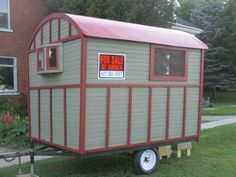 a tiny house on wheels with a for sale sign