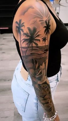 a woman with a tattoo on her arm is standing in front of the ocean and palm trees