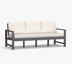 a black and white couch sitting on top of a wooden frame