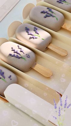 four popsicles with lavender flowers on them