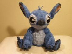 a blue crocheted stuffed animal sitting on top of a table