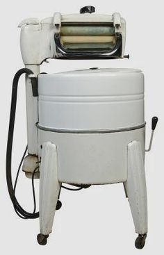 a large white machine sitting on top of a metal stand with a hose attached to it