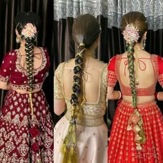 three women in different colored dresses with braids and flowers on their hair, one is wearing