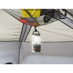 a light hanging from the ceiling in a tent