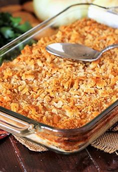 a casserole dish with bread crumbs and a spoon