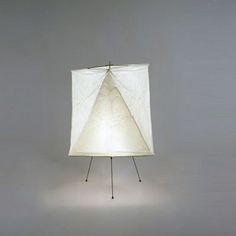 a lamp that is on top of a stand with a white cloth covering it's face