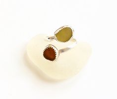 Sea glass jewelry If you like to make a statement with your jewelry, then this is the ring for you. This yellow and brown sea glass ring holds two pieces of beautiful genuine sea glass. The yellow piece may be UV glass. The design is unique and bold. It would make a great anniversary gift for a wife . It would also be a stunning keepsake for a beach lover. I have created the bezel setting with fine silver. Next the bezel setting was soldered onto a handcrafted sterling silver band. And finally t Adjustable Sea Glass Ring Jewelry, Brown Sea, Sea Glass Ring, Great Anniversary Gifts, Sea Glass Bracelet, Silver Gift Box, Christmas Gifts For Wife, Glass Ring, Sterling Silver Wire Wrap