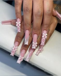 a manicure with pink and white designs on it