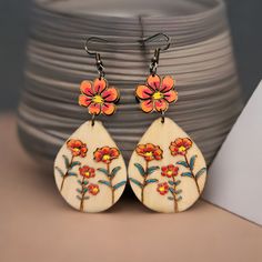 Boho Floral Wooden Earrings – Hand-Painted & Nature-Inspired Celebrate your love of nature with these beautiful wooden earrings featuring hand-painted floral motifs. Each flower is carefully engraved and painted on lightweight wood treated with linseed oil for durability. These 2-inch long earrings are the perfect accessory for you who embrace a minimalist and bohemian style without losing elegance. The picture may not reflect the actual color of the items due to differences in screen's pixel. Artsy Hand Painted Flower Earrings, Bohemian Flower Earrings As Gift, Bohemian Floral Print Flower Earrings As Gift, Bohemian Multicolor Floral Print Earrings, Unique Hand Painted Flower Drop Earrings, Bohemian Drop Earrings With Floral Print, Bohemian Floral Print Drop Earrings, Bohemian Hand Painted Flower Earrings, Artistic Hand Painted Flower Earrings