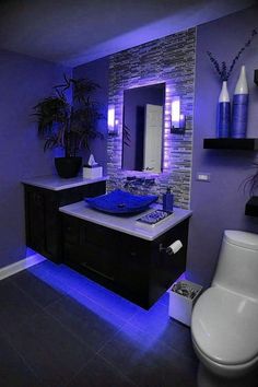 a bathroom with purple lighting in it