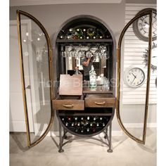 a wine rack with bottles on it in front of a wall clock and other items