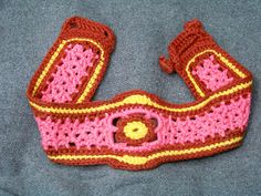 This vintage 1970s Mod belt was hand crocheted from cotton rug yarn. The colors are rust, yellow-gold, and hot pink. There is a crocheted flower shape in rust and yellow-gold in the center front of the belt. The actual yarn colors are a bit less intense than the photos. A delightful bohemian accessory. The belt closes in the back by two crocheted buttons  that fit into button holes. This item is wearable art. This belt is NOT adjustable. It fits a 29 in. waist. Fits MAXIMUM body measurement: Wai 70s Mod, Crocheted Flower, Retro Bohemian, Mod Vintage, Rug Yarn, Bohemian Accessories, Vintage Belts, Cotton Rug, Yarn Colors