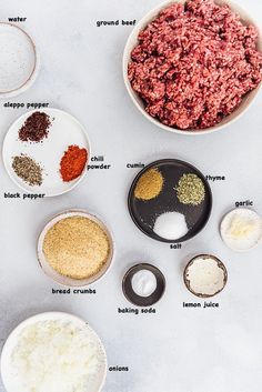 the ingredients to make hamburger patties laid out on a white counter top, including ground beef and seasonings