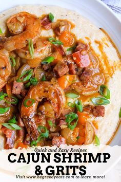 a white plate topped with shrimp and grits on top of a tortilla