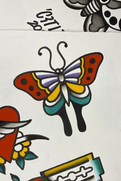 some colorful tattoos on white paper with black and red designs in the middle one has a butterfly