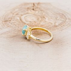 a gold ring with two stones on it