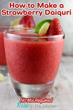 strawberry daiquita smoothie in a glass with limes and strawberries