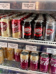 several cans of soda on display in a store