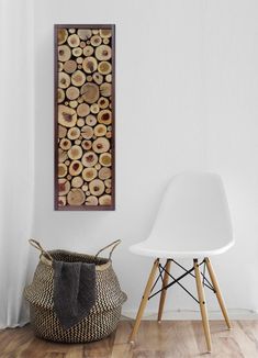 a white chair sitting in front of a wall mounted wood art piece on a wall