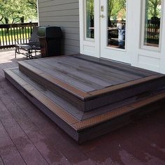 a large wooden deck on the side of a house