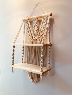 a macrame hanging on the wall next to a shelf