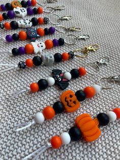 halloween bead necklaces are laying on the floor