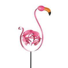 a pink flamingo standing on top of a metal pole