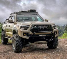 a toyota truck parked on top of a dirt road