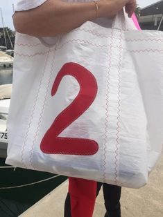 a person carrying a bag with the number two on it