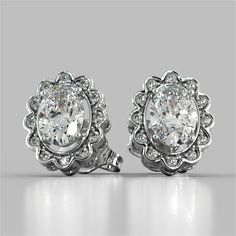 Spruce up your ensemble with this captivating set. This stunning Oval Cut Style earrings are set amidst a halo of Simulated Diamonds that are blooming like a flower with matching cutout detail on the sides. Elegant and feminine, this set is sure to impress. Oval Cut Halo Earrings Center Stone: 1CT Each Total Carat Weight: 2.12CTW Stone Clarity: VVS-1 Precious Metal: 925 Sterling Silver Model: ER2500-WH-SL White Gold Earrings Studs, Round Halo, Halo Earrings, Halo Earrings Studs, Gold Models, Moissanite Earrings, White Gold Earrings, Fine Earrings, Metal Earrings