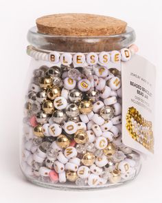 a jar filled with lots of different types of beads