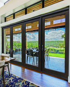 a dining room with sliding glass doors leading to an outdoor patio and view of the countryside