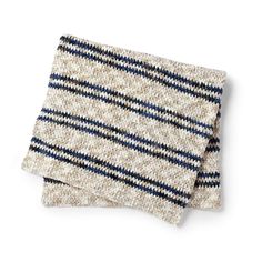 two white and blue striped napkins sitting on top of each other with one folded