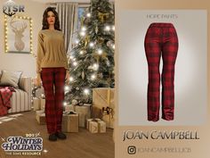 an image of a woman standing in front of a christmas tree wearing red and black plaid pants