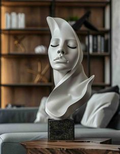 a white sculpture sitting on top of a wooden table