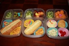 four plastic containers filled with food on top of a wooden table