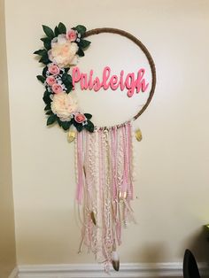 an image of a wall hanging decoration with flowers and the word hello written on it