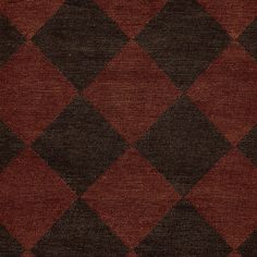 a red and brown rug with black squares on it