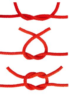 three red ropes tied together with one knot in the middle and two at the end